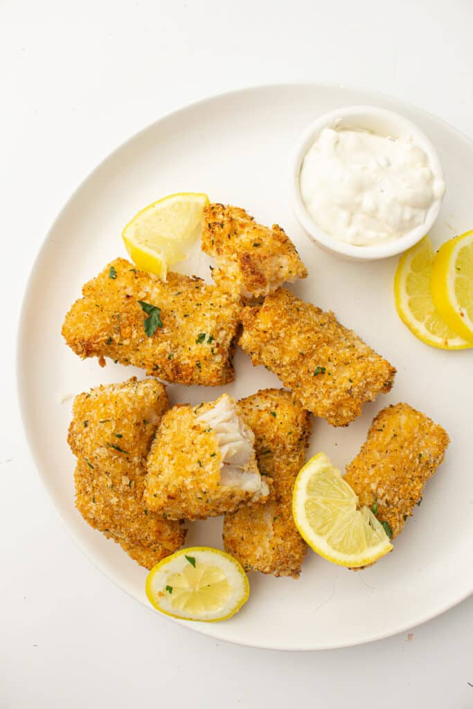 Cooked Air Fryer Fish on a plate with lemon slices