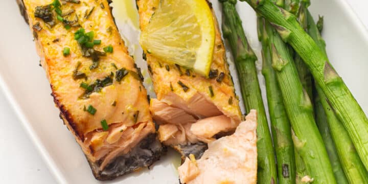 Air fryer salmon on a plate with asparagus