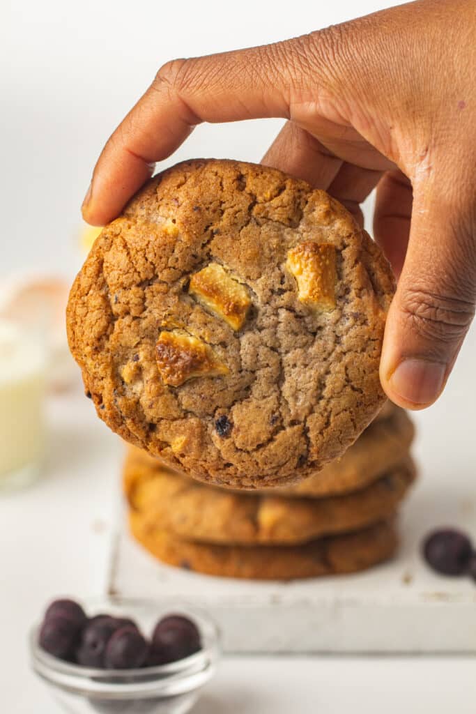 Blueberry and White Chocolate Cookies being held up