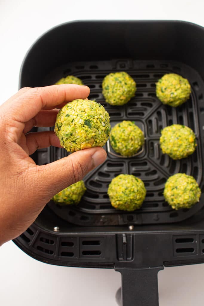 Uncooked falafel being held up