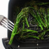 Air Fryer Broccolini being held up by fork