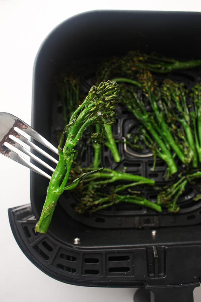 Air Fryer Broccolini being held up by a fork