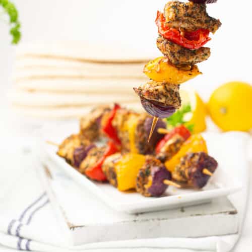 Air fryer chicken skewers being held up