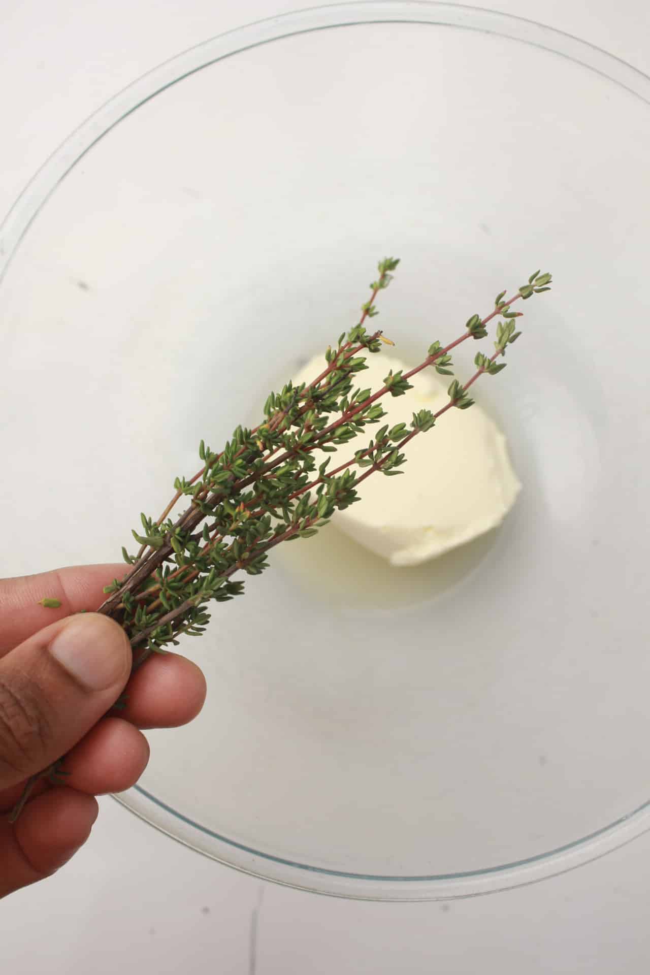 Putting thyme leaves in the bowl