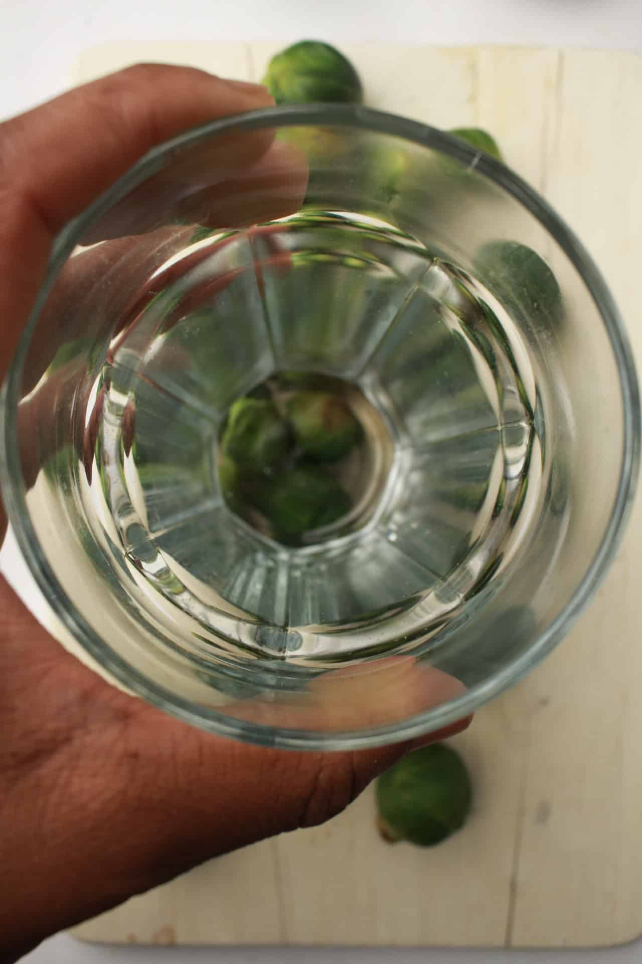 Smashing  brussel sprouts with a glass