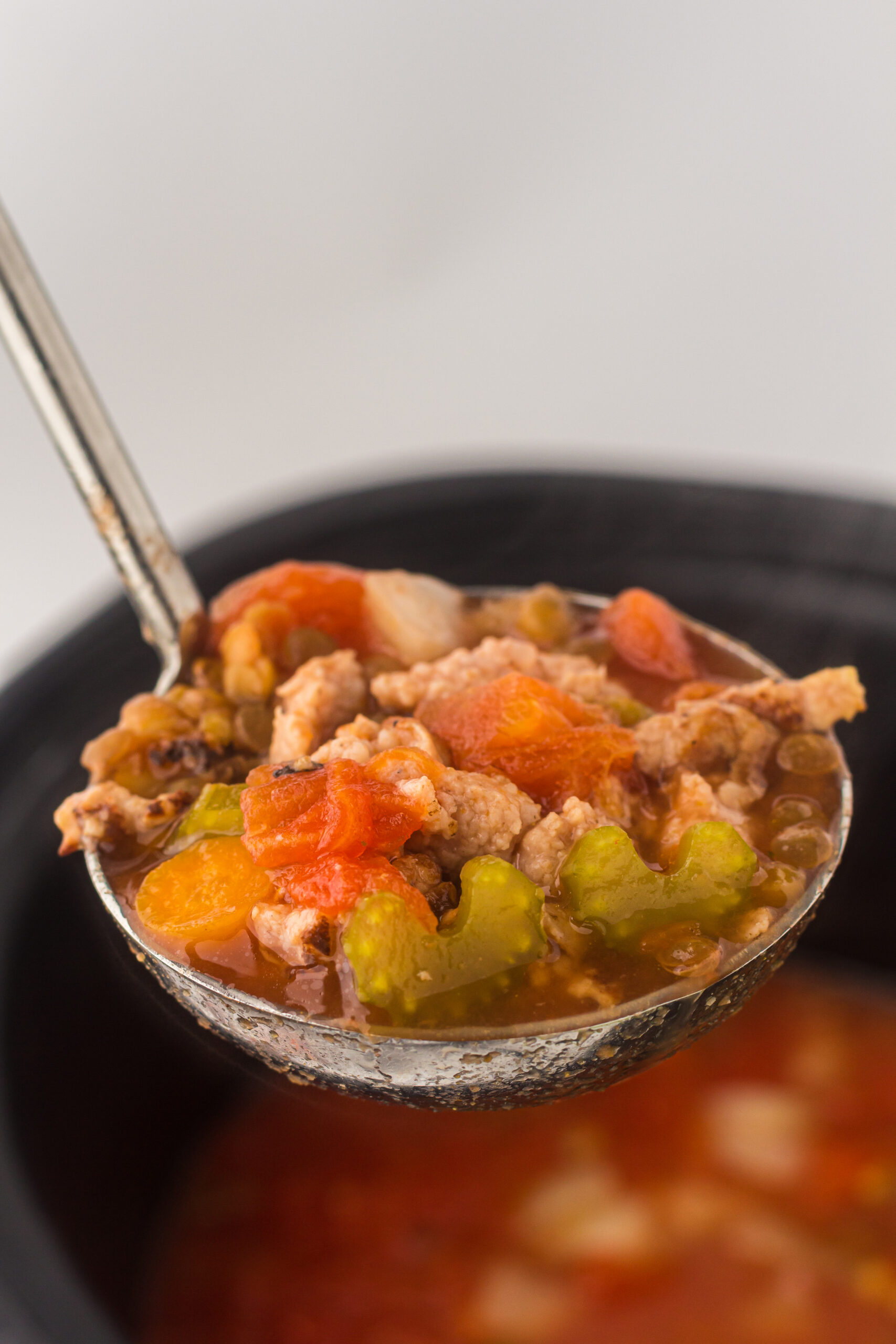 Slow Cooker Lentil and Sausage Soup in a ladle