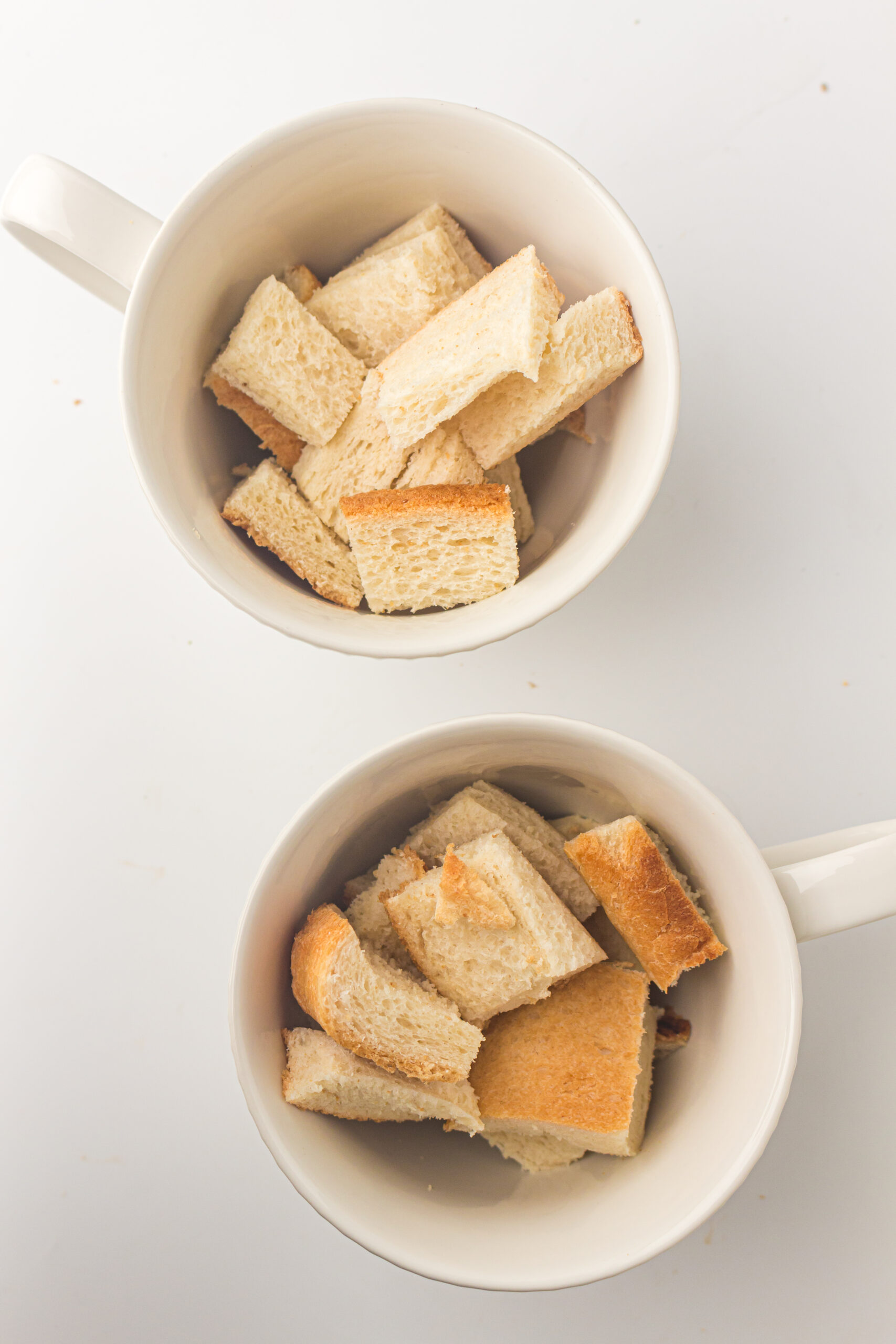 Cut up bread in a greased bowl