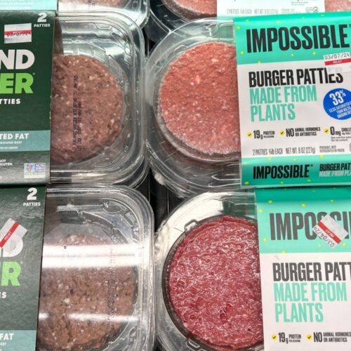 Grocery store refrigerator section with Beyond and Impossible Burger brand plant based patties
